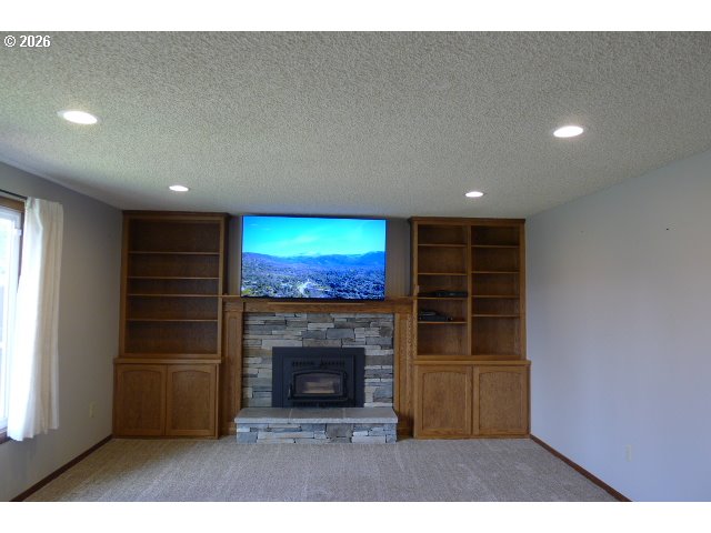 412 Camellia Court Reedsport, OR 97467 - Photo 36 of 48 a living room with a fireplace