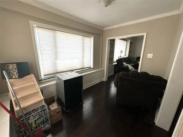 a living room with furniture window and a flat screen tv