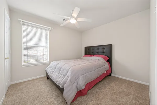 a bed sitting in a bedroom next to a window