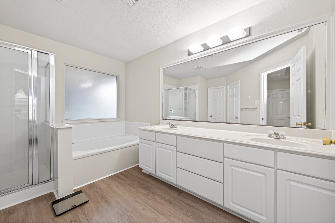 22603 Spring Crossing Drive Spring, TX 77373 - Photo 16 of 22 a spacious bathroom with a tub sink and mirror