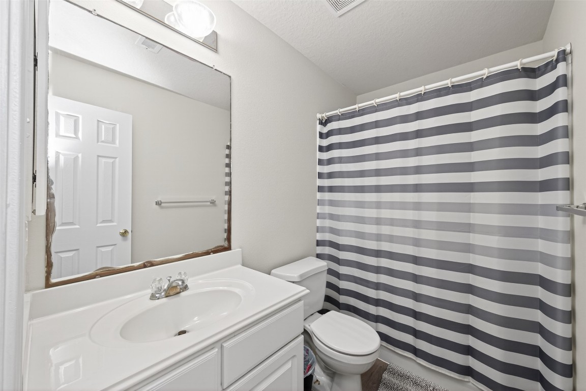 22603 Spring Crossing Drive Spring, TX 77373 - Photo 16 of 29 a bathroom with a sink toilet and shower