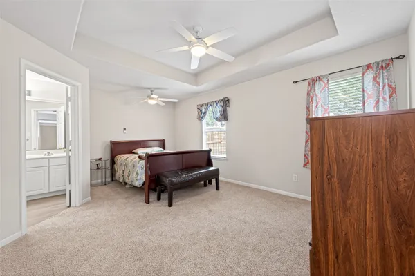 a bed room with a bed and a ceiling fan