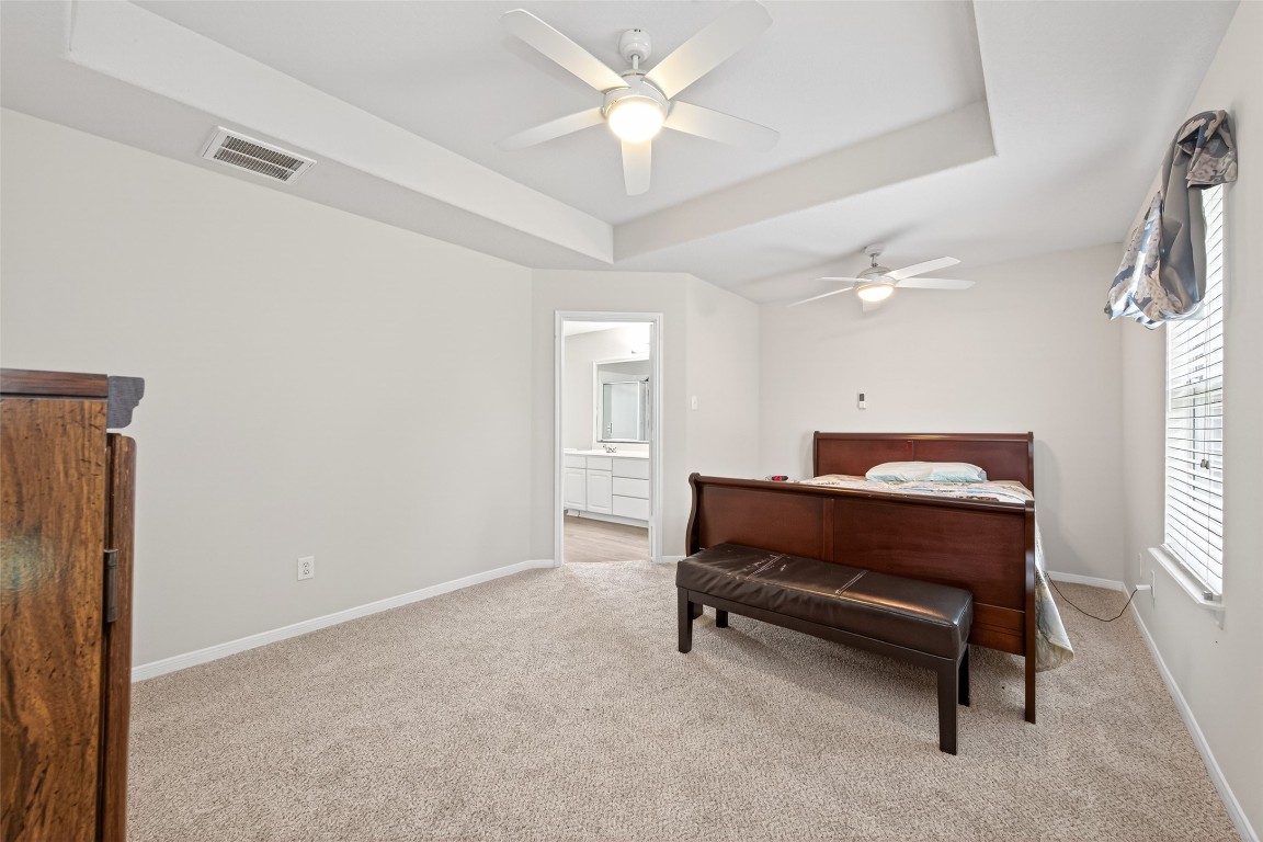 22603 Spring Crossing Drive Spring, TX 77373 - Photo 18 of 29 a room with a bed and a chandelier