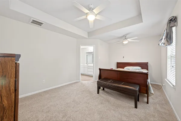 a room with a chair and a ceiling fan