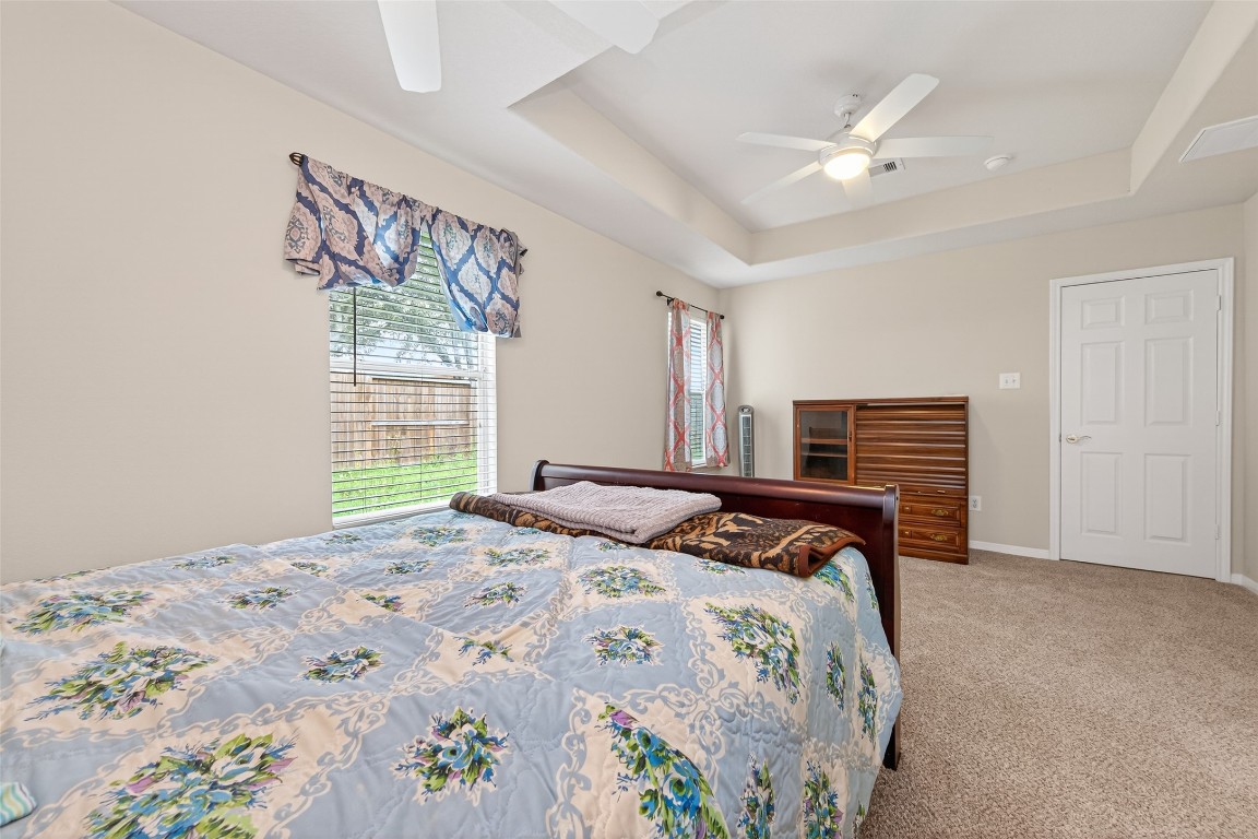 22603 Spring Crossing Drive Spring, TX 77373 - Photo 19 of 29 a bedroom with a large bed and a chandelier