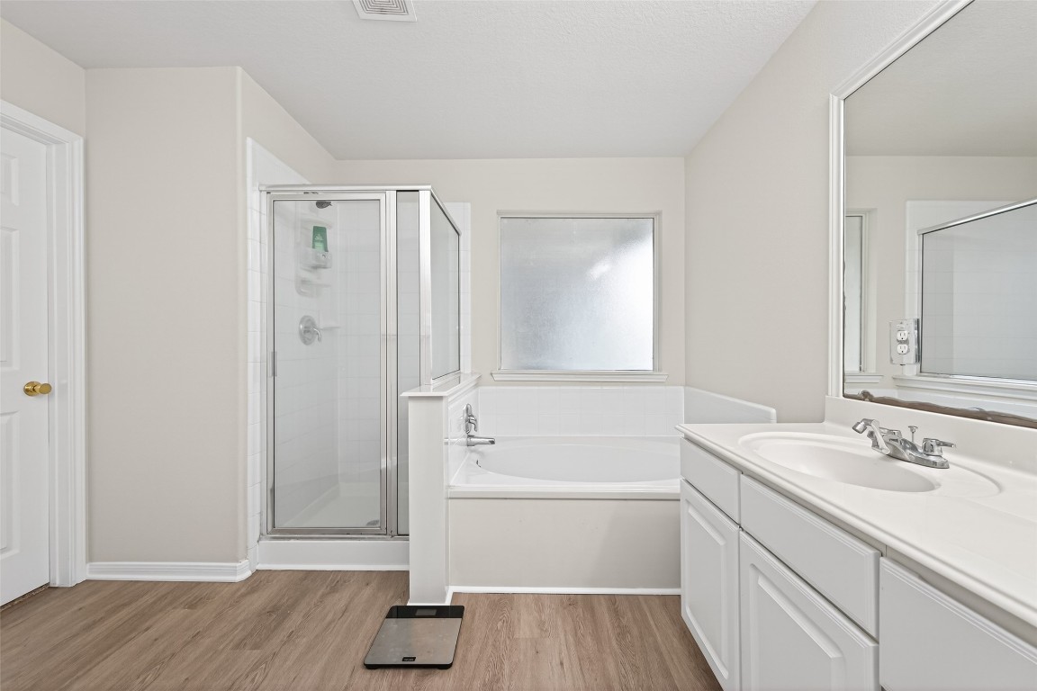 22603 Spring Crossing Drive Spring, TX 77373 - Photo 21 of 29 a bathroom with a sink a toilet and shower