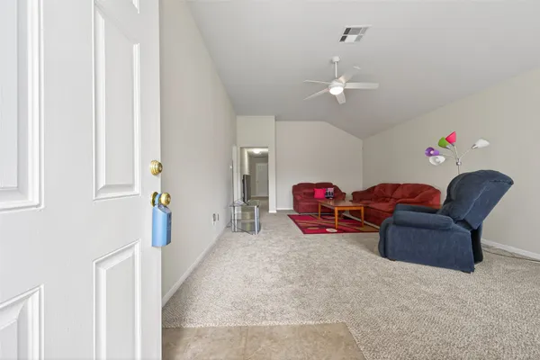 a living room with furniture a couch and a chandelier