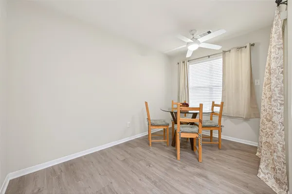 a dining room with furniture and wooden floor