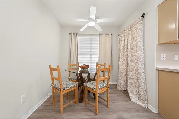 a dining room with furniture and window