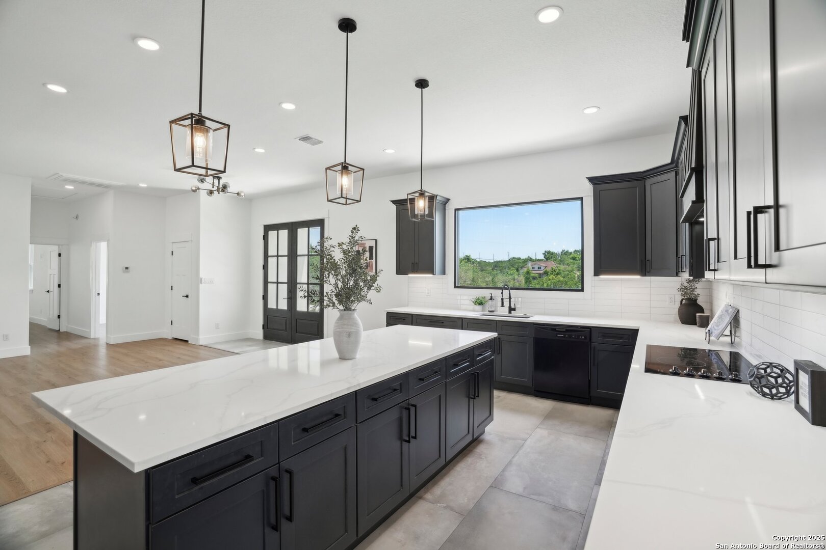 a kitchen with stainless steel appliances kitchen island granite countertop a sink and a refrigerator