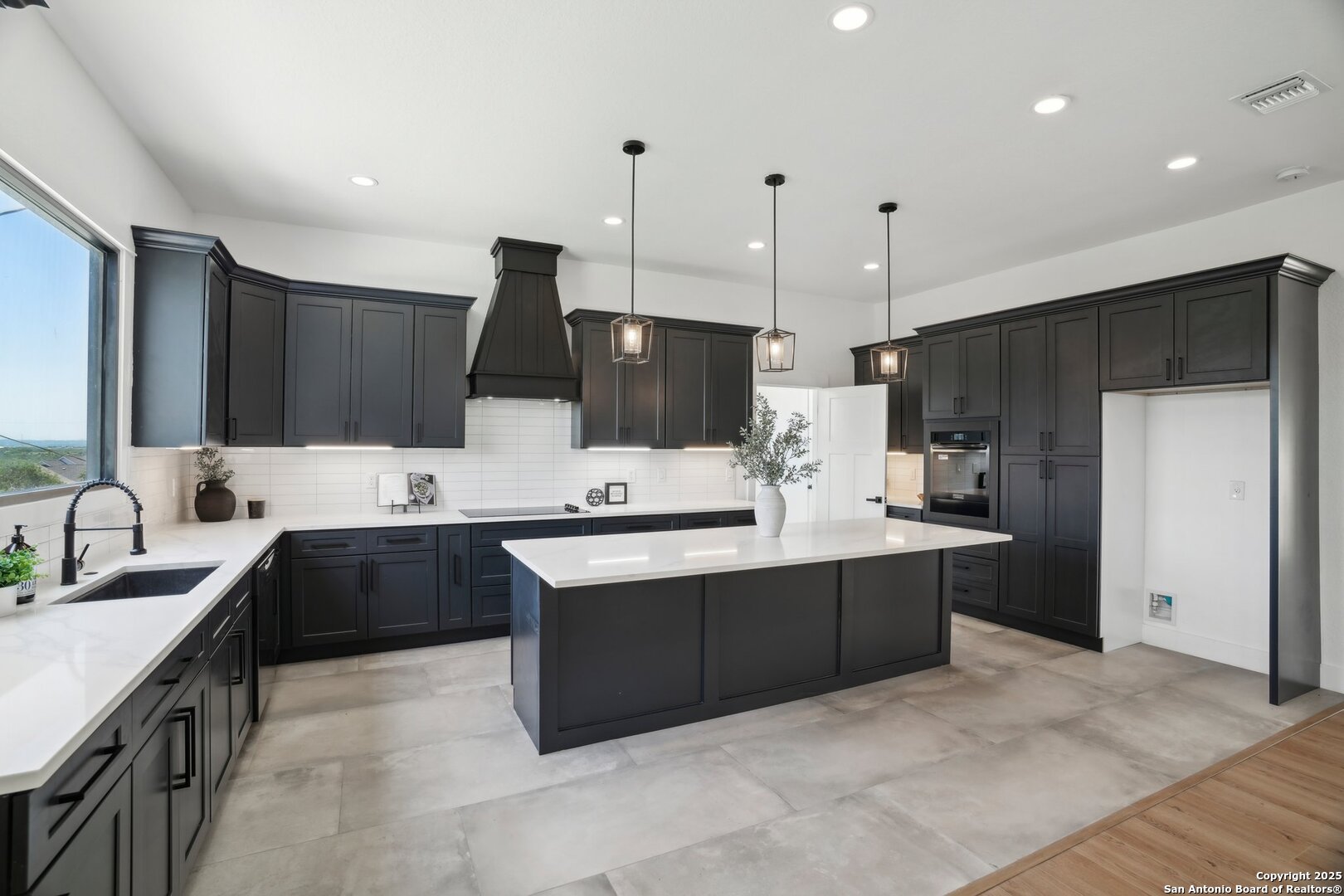 166 Magnolia Meadow Spring Branch, TX 78070 - Photo 12 of 41 a large kitchen with kitchen island a sink stainless steel appliances and cabinets