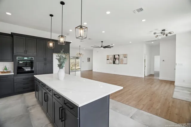 a kitchen with kitchen island a sink stove and refrigerator