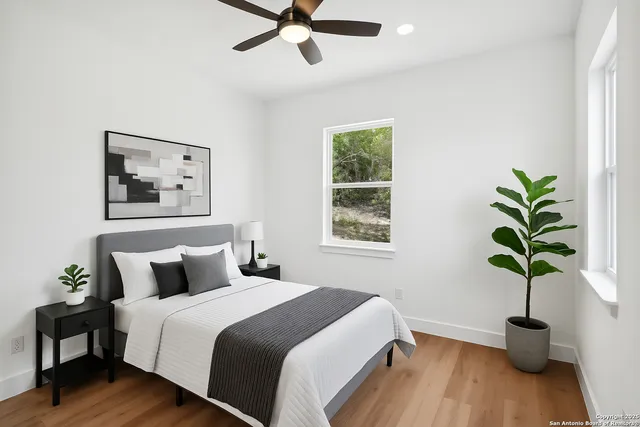 a bedroom with a bed and a potted plant