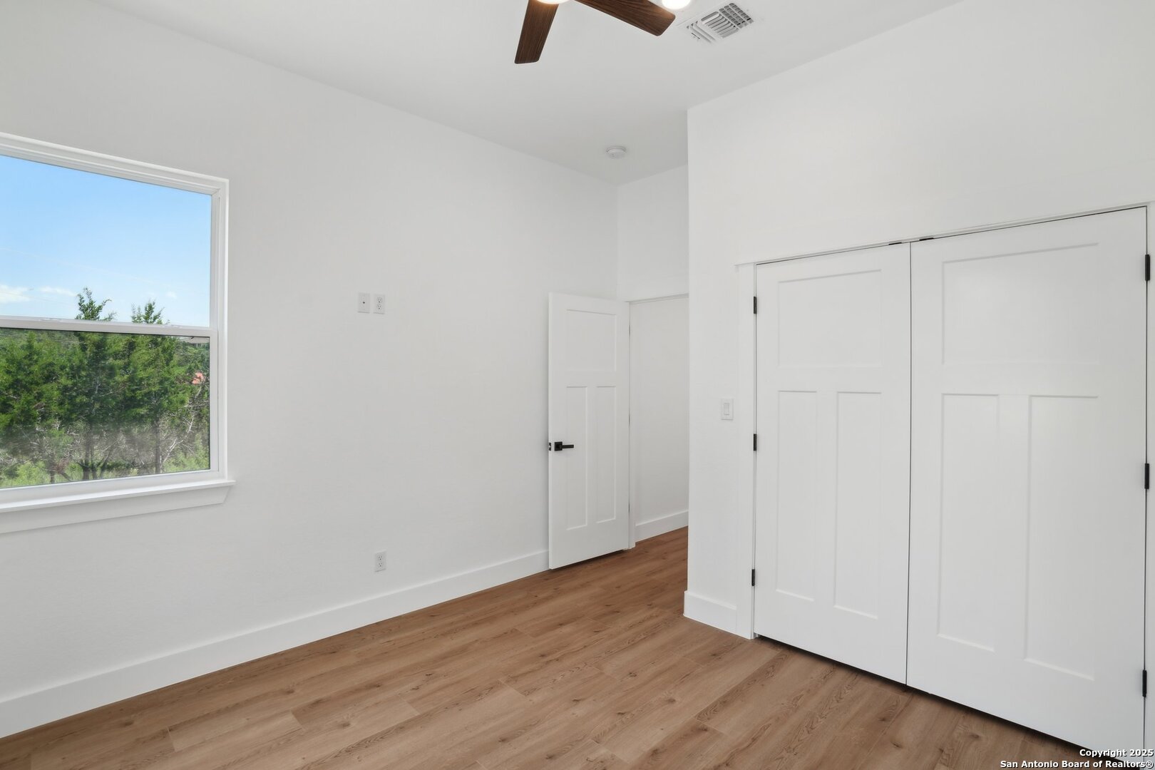 166 Magnolia Meadow Spring Branch, TX 78070 - Photo 19 of 41 a view of an empty room with wooden floor and a window