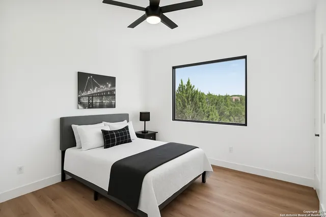 a bedroom with a bed and a painting on the wall