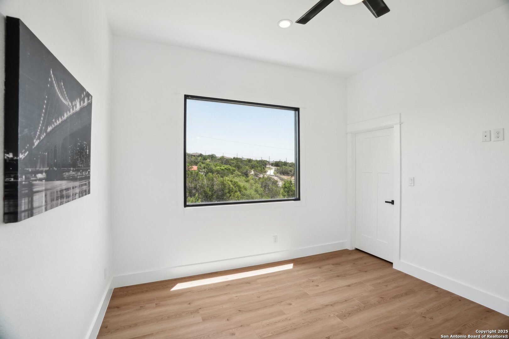 166 Magnolia Meadow Spring Branch, TX 78070 - Photo 23 of 41 a view of an empty room with wooden floor and a window