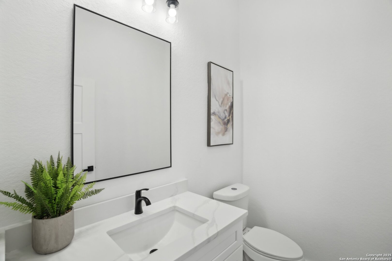 166 Magnolia Meadow Spring Branch, TX 78070 - Photo 24 of 41 a bathroom with a sink a toilet and a mirror