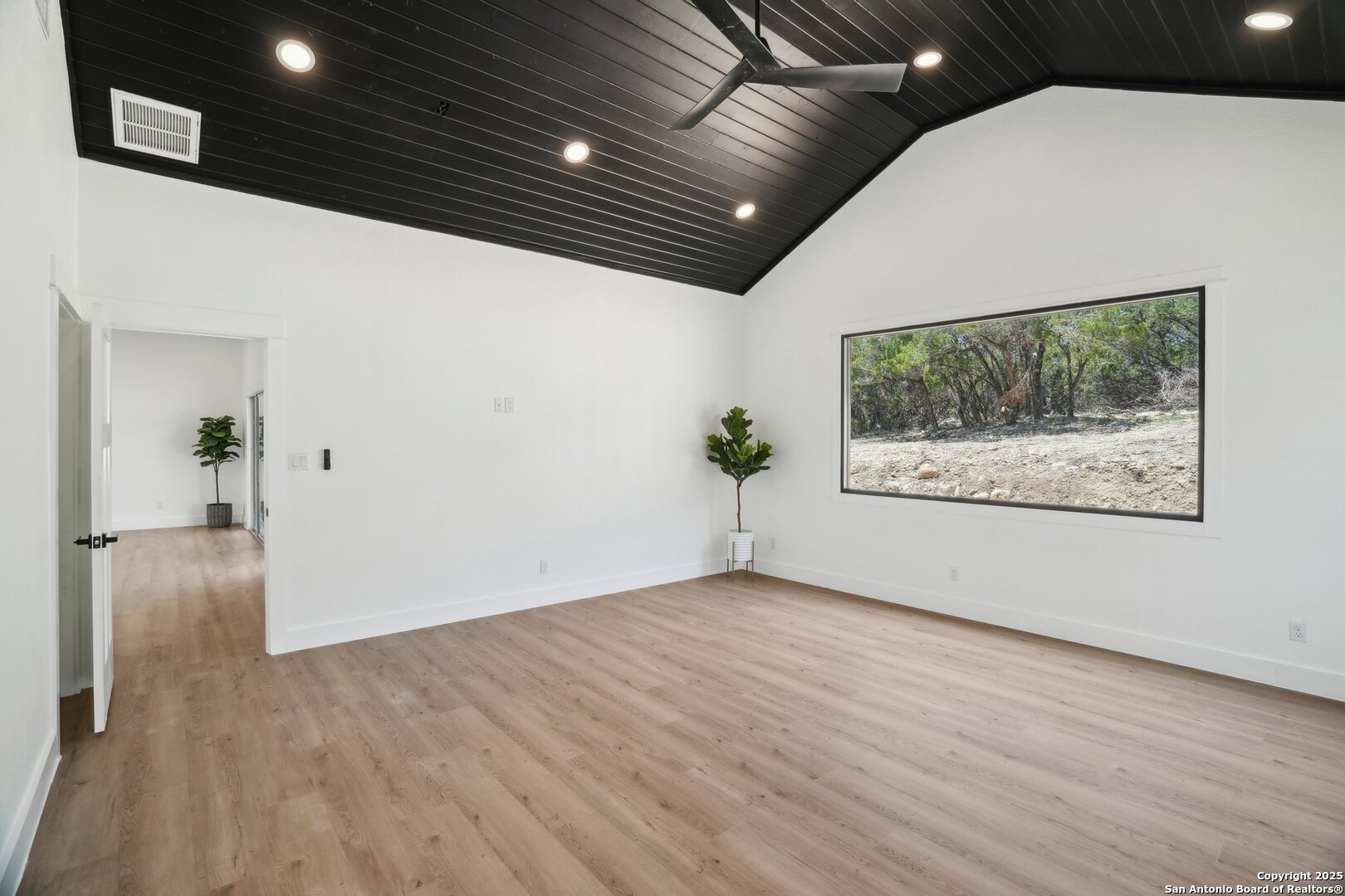 166 Magnolia Meadow Spring Branch, TX 78070 - Photo 27 of 41 a view of an empty room with wooden floor and a painting on the wall