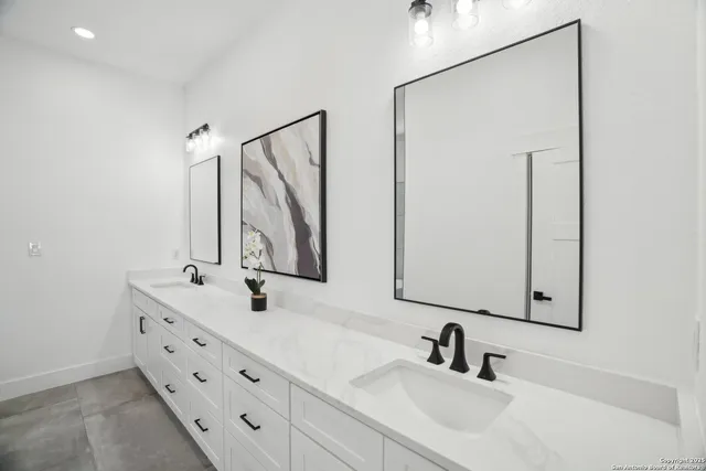 a bathroom with double vanity sink and a mirror