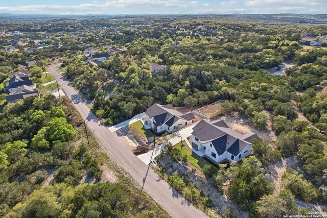 an aerial view of a house with a yard