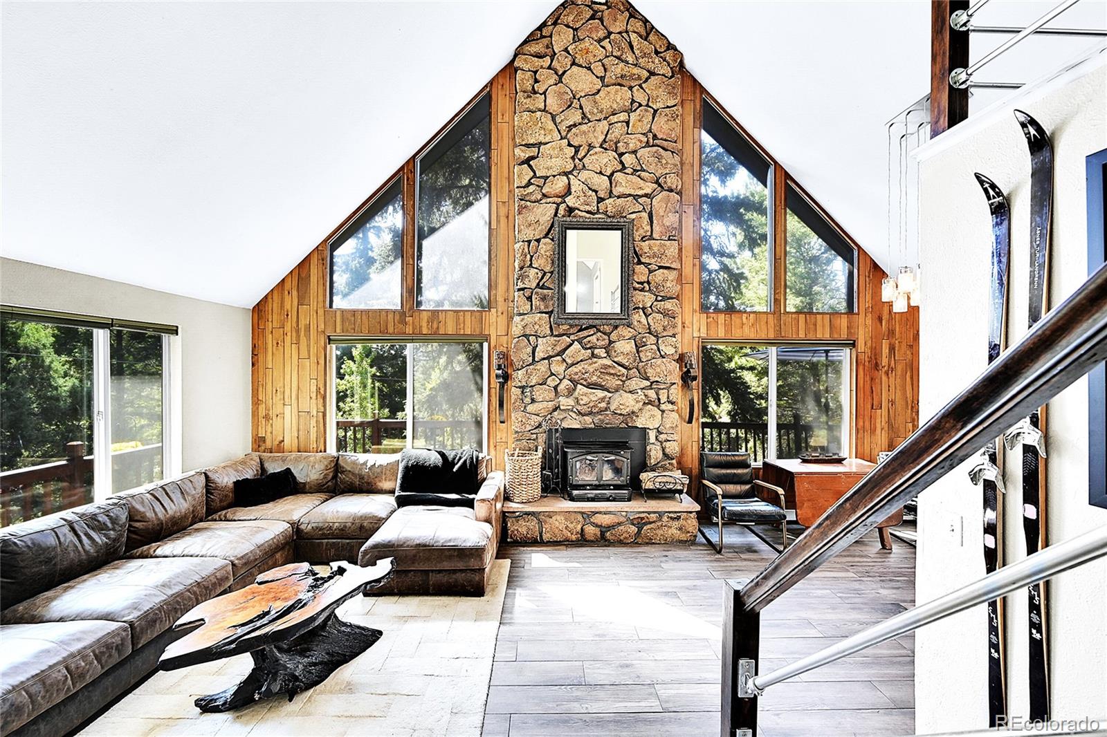 30997 Witteman Road Conifer, CO 80433 - Photo 9 of 39 a living room with furniture and a floor to ceiling window