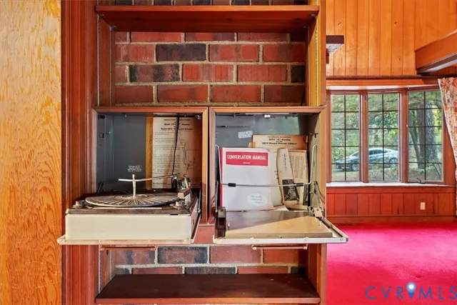 a view of a brick house with large windows