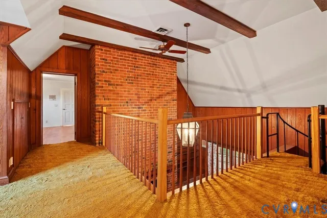 a view of a hallway with wooden floor and a chandelier