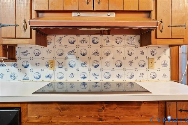 a view of an empty room with wooden floor and a fireplace