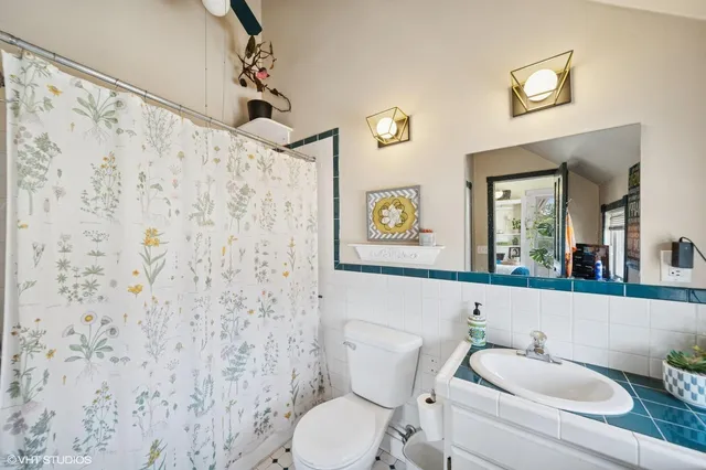 a bathroom with a toilet sink and mirror