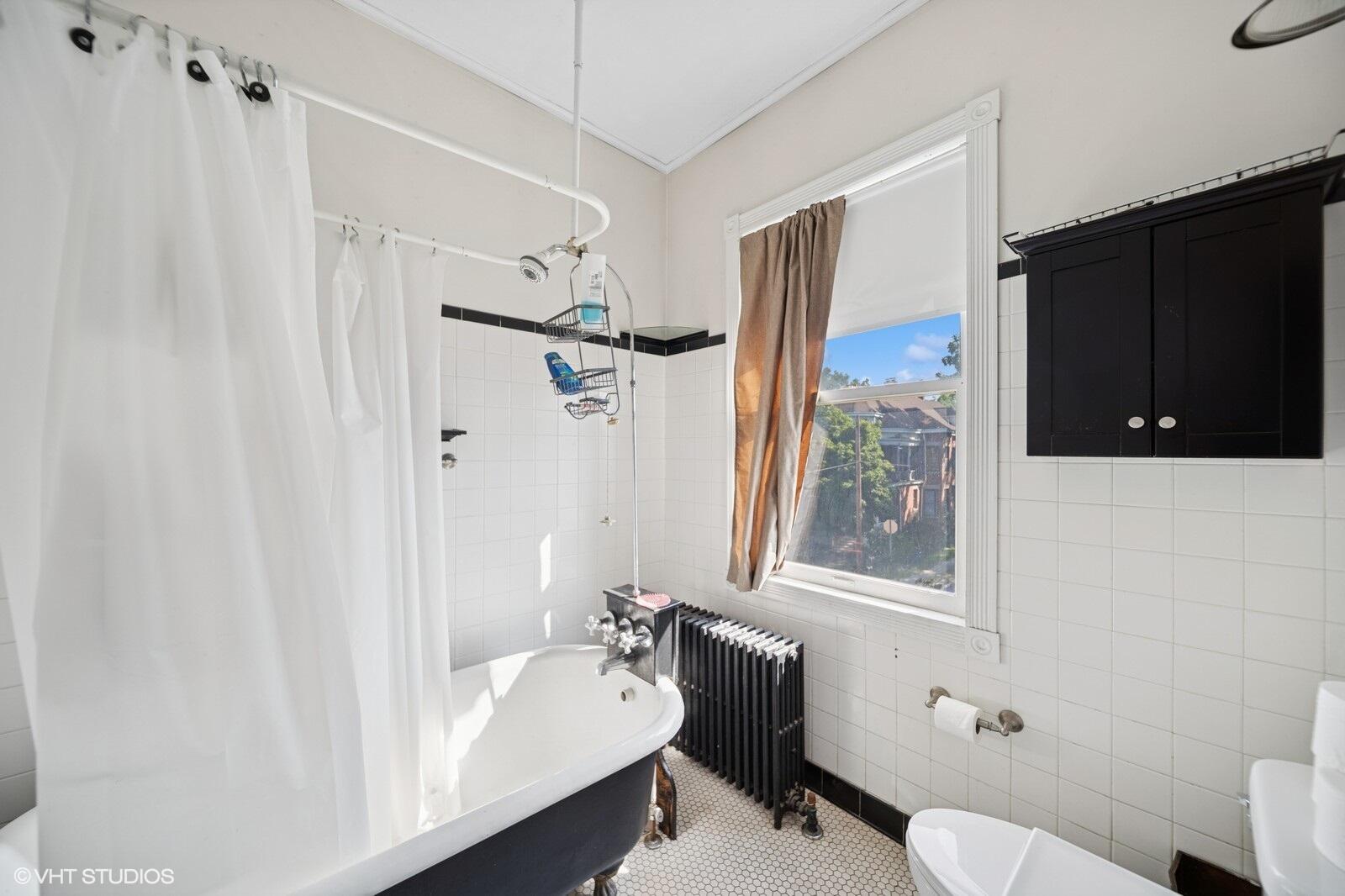 717 Pine Street Michigan City, IN 46360 - Photo 14 of 20 a bathroom with a sink toilet and shower