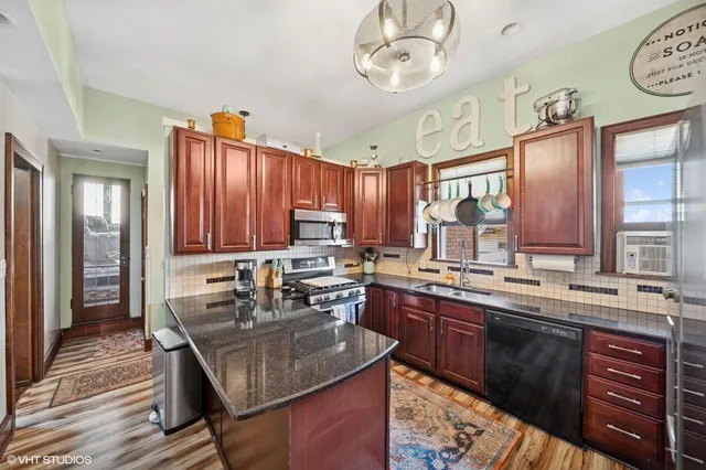a kitchen with a sink stove and cabinets