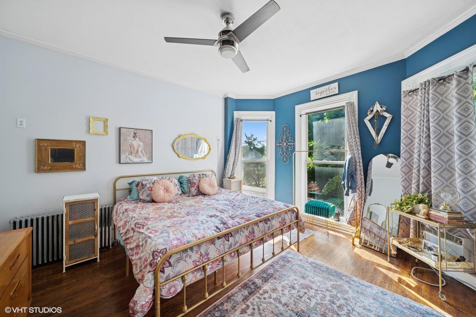 717 Pine Street Michigan City, IN 46360 - Photo 9 of 20 a bedroom with a bed a dresser and wooden floor