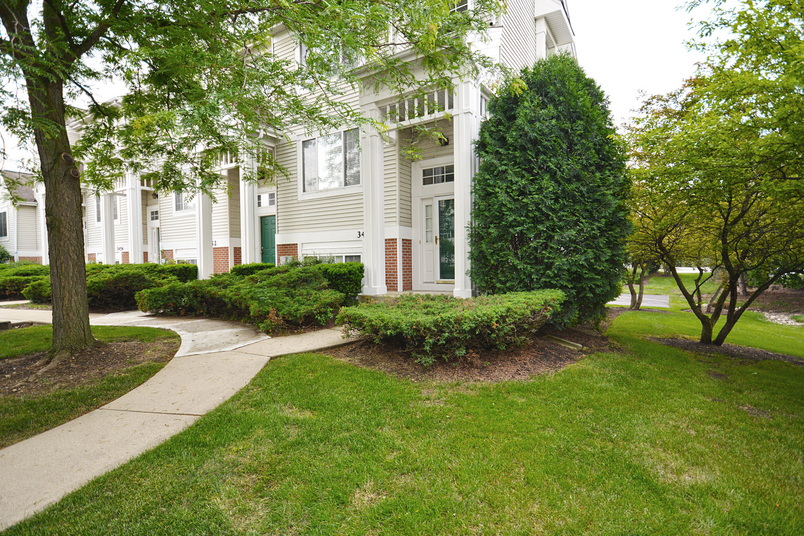 3450 Ravinia Circle Aurora, IL 60504 - Photo 1 of 13 a front view of a house with garden