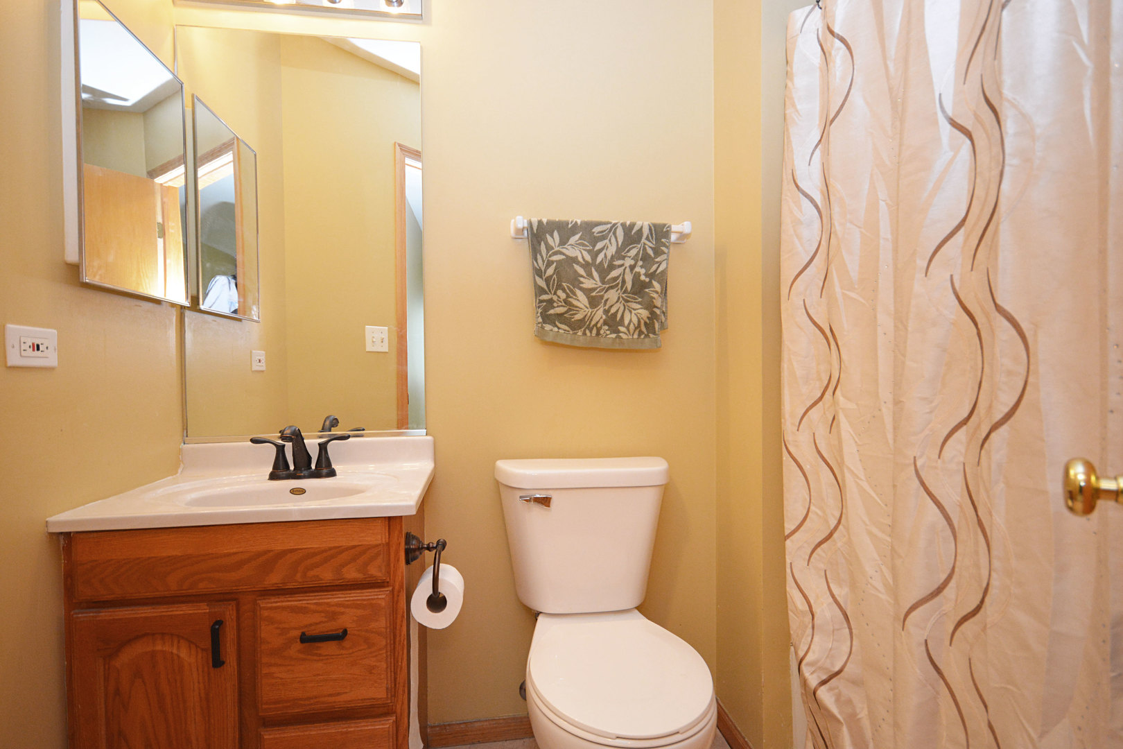 3450 Ravinia Circle Aurora, IL 60504 - Photo 13 of 13 a bathroom with a toilet sink and mirror