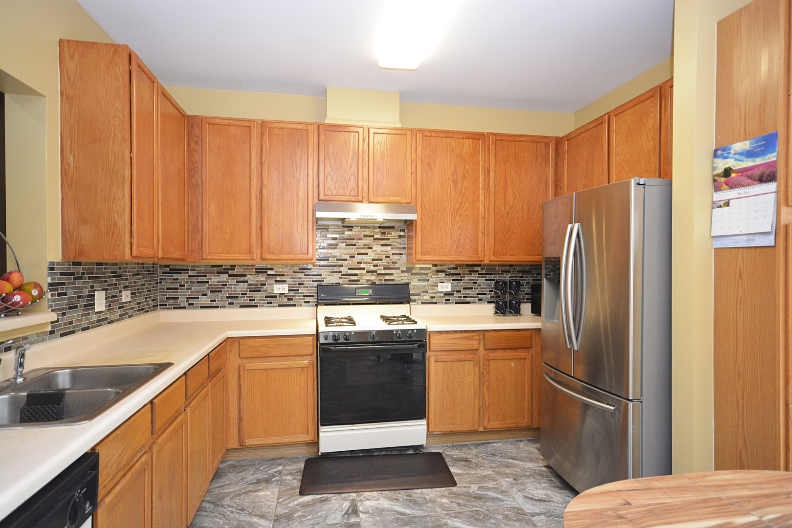 3450 Ravinia Circle Aurora, IL 60504 - Photo 5 of 13 a kitchen with stainless steel appliances granite countertop a refrigerator a sink dishwasher a stove with white cabinets and wooden floor