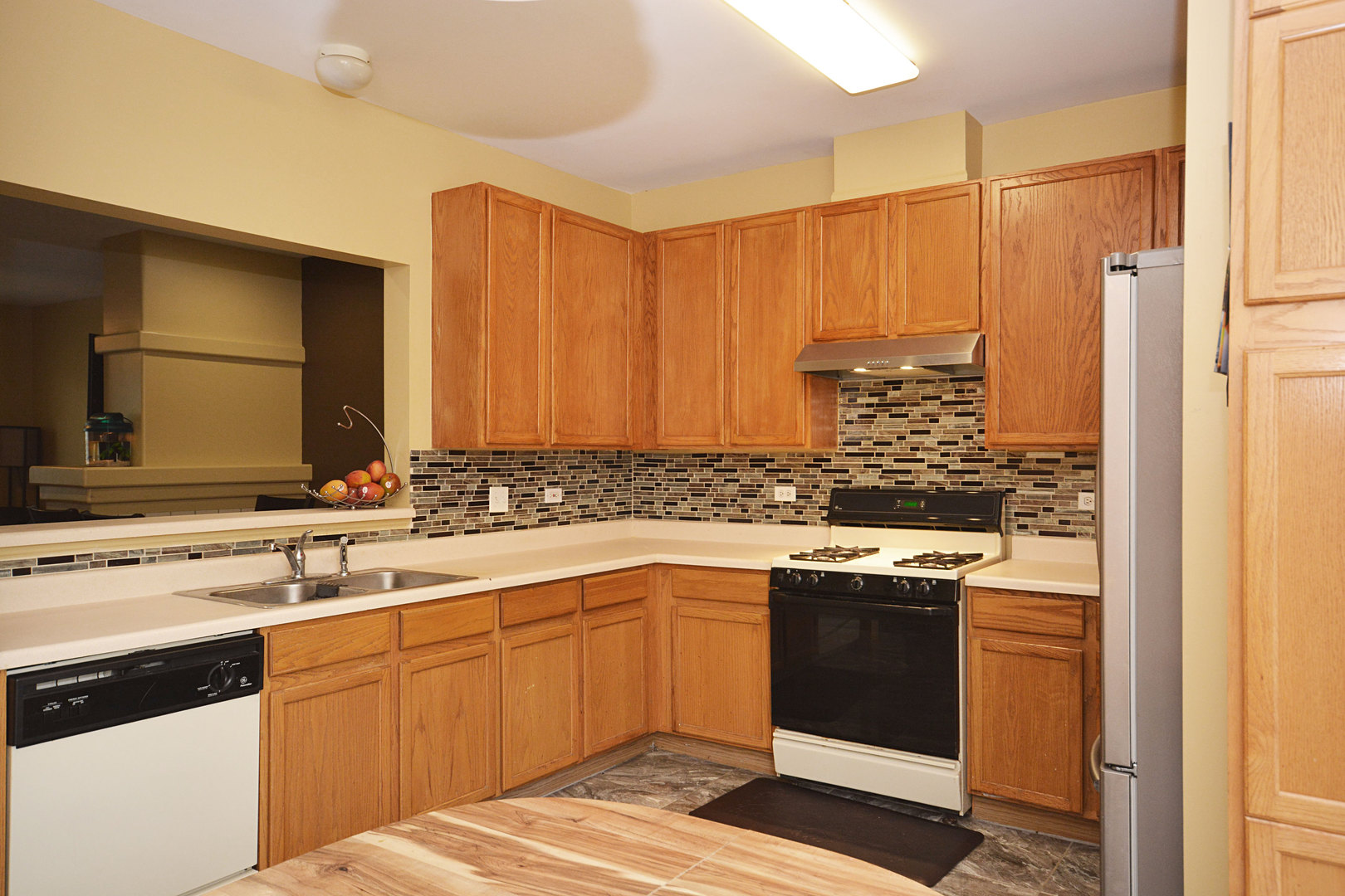 3450 Ravinia Circle Aurora, IL 60504 - Photo 6 of 13 a kitchen with a sink stove and cabinets