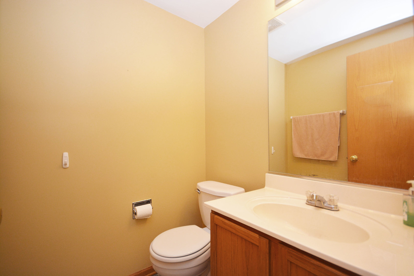 3450 Ravinia Circle Aurora, IL 60504 - Photo 7 of 13 a bathroom with a sink a toilet and mirror