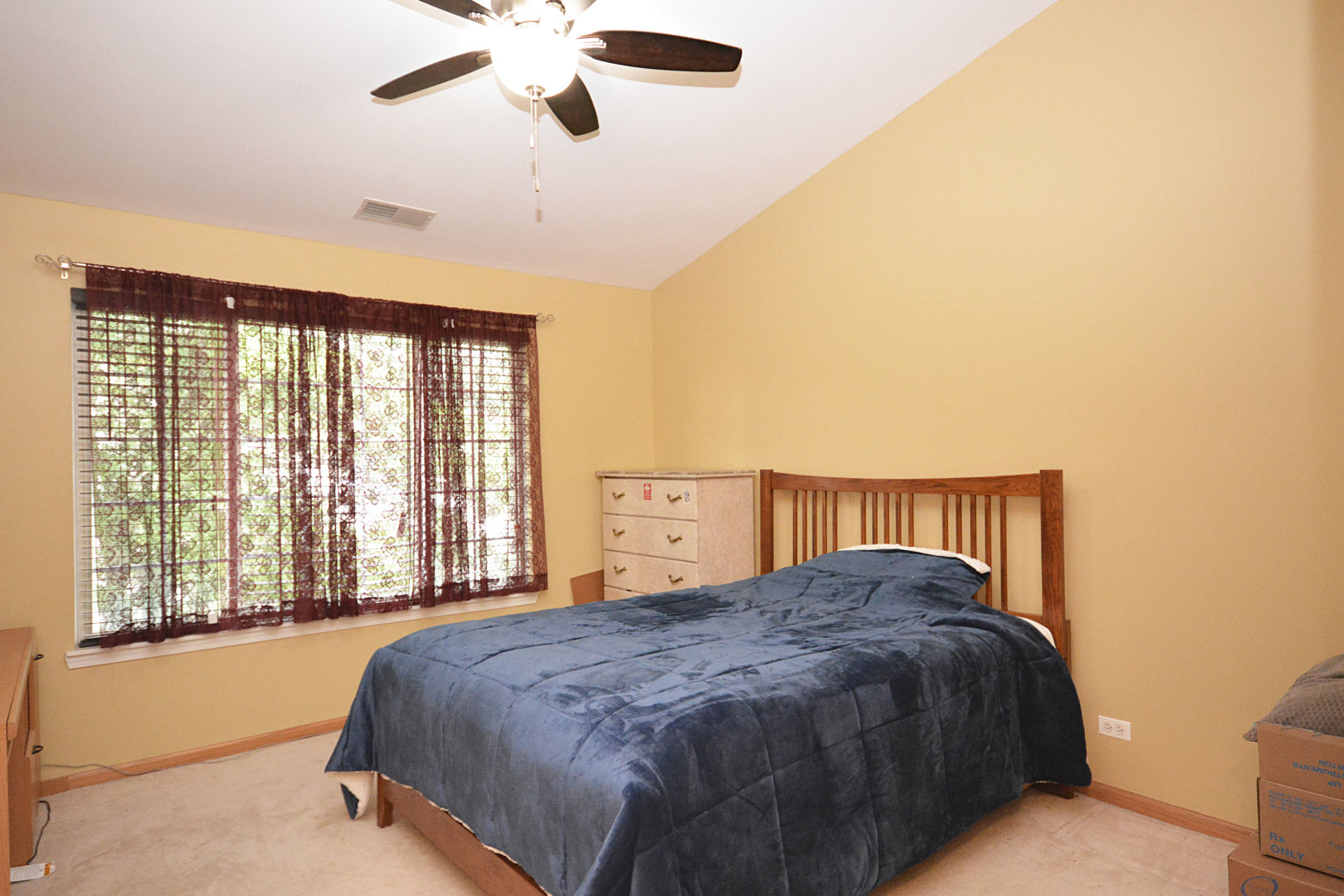 3450 Ravinia Circle Aurora, IL 60504 - Photo 9 of 13 a bed sitting in a spacious bedroom next to a window
