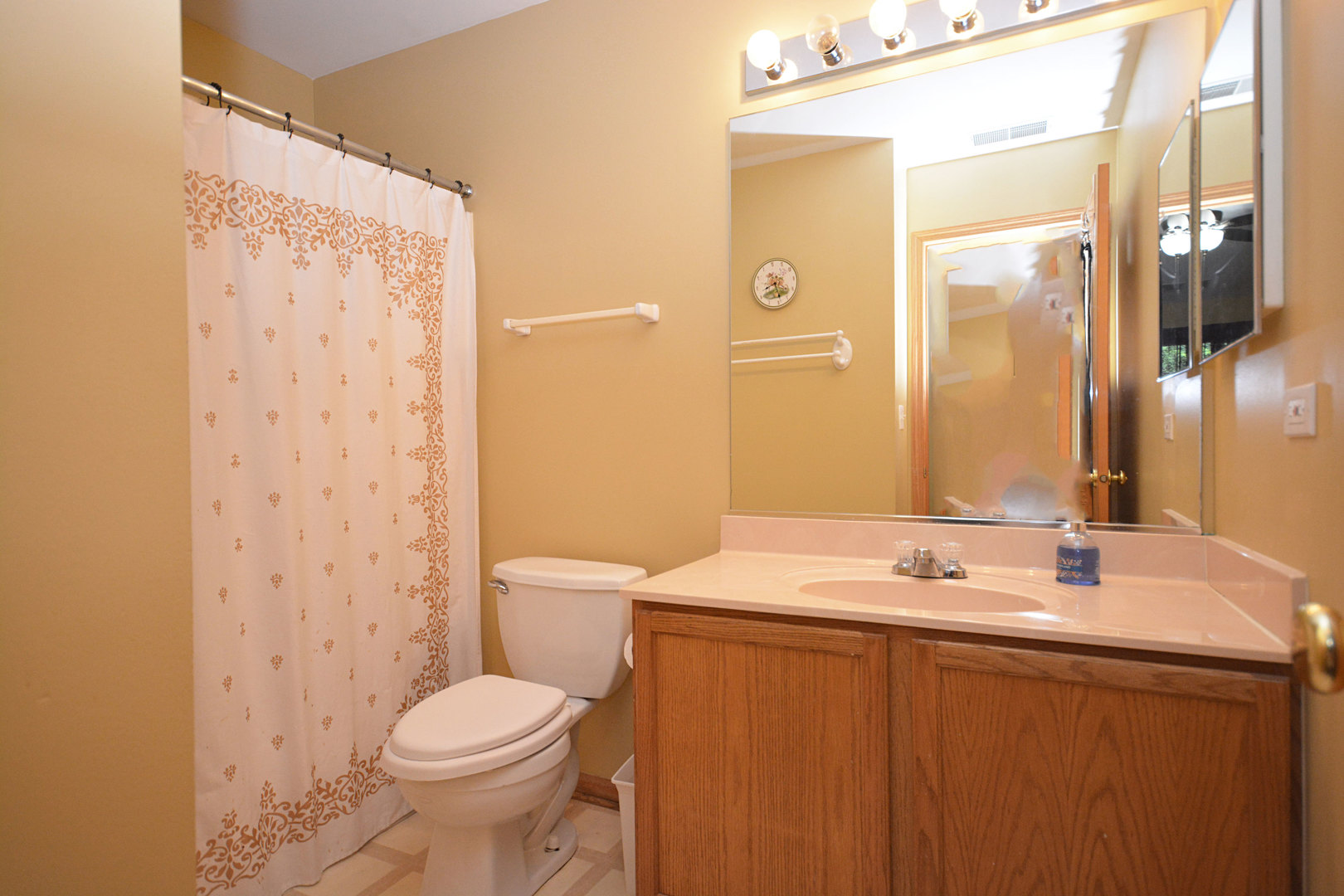 3450 Ravinia Circle Aurora, IL 60504 - Photo 10 of 13 a bathroom with a sink a toilet and shower