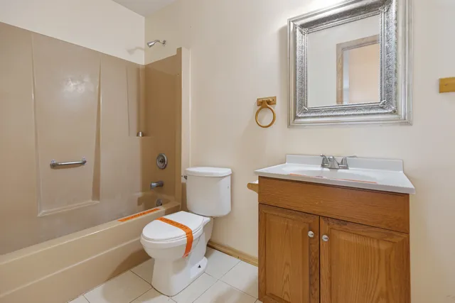 a bathroom with a granite countertop toilet a sink and a bathtub