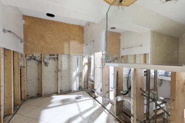 a spacious bathroom with a shower sink and mirror