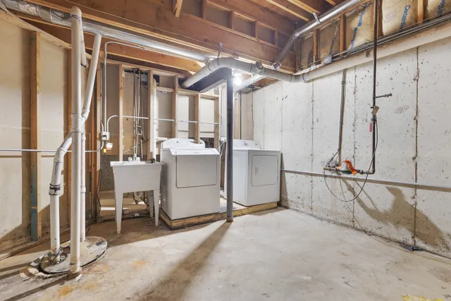 a view of a hallway with a computer on a desk and chair