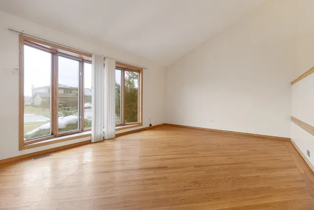 a view of an empty room with glass door