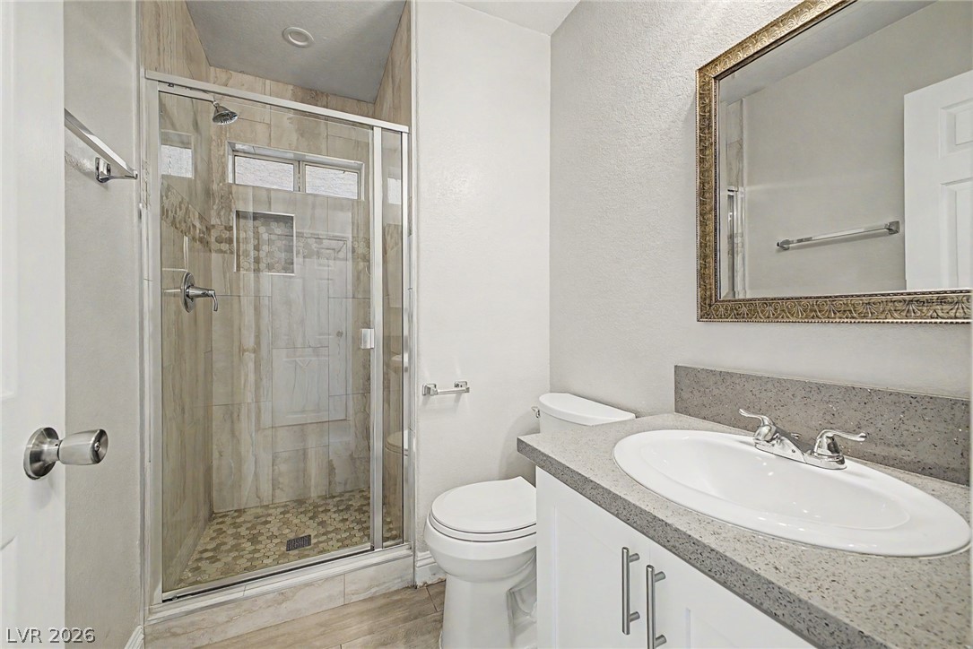 2316 Ramsgate Drive Henderson, NV 89074 - Photo 14 of 28 A well-appointed bathroom features a glass-enclosed shower with tiled walls and a functional vanity with ample counter space.