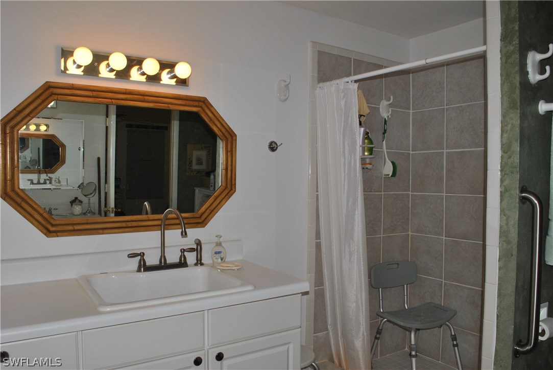 5824 Mackerel Road Bokeelia, FL 33922 - Photo 20 of 25 a bathroom with a sink and a mirror