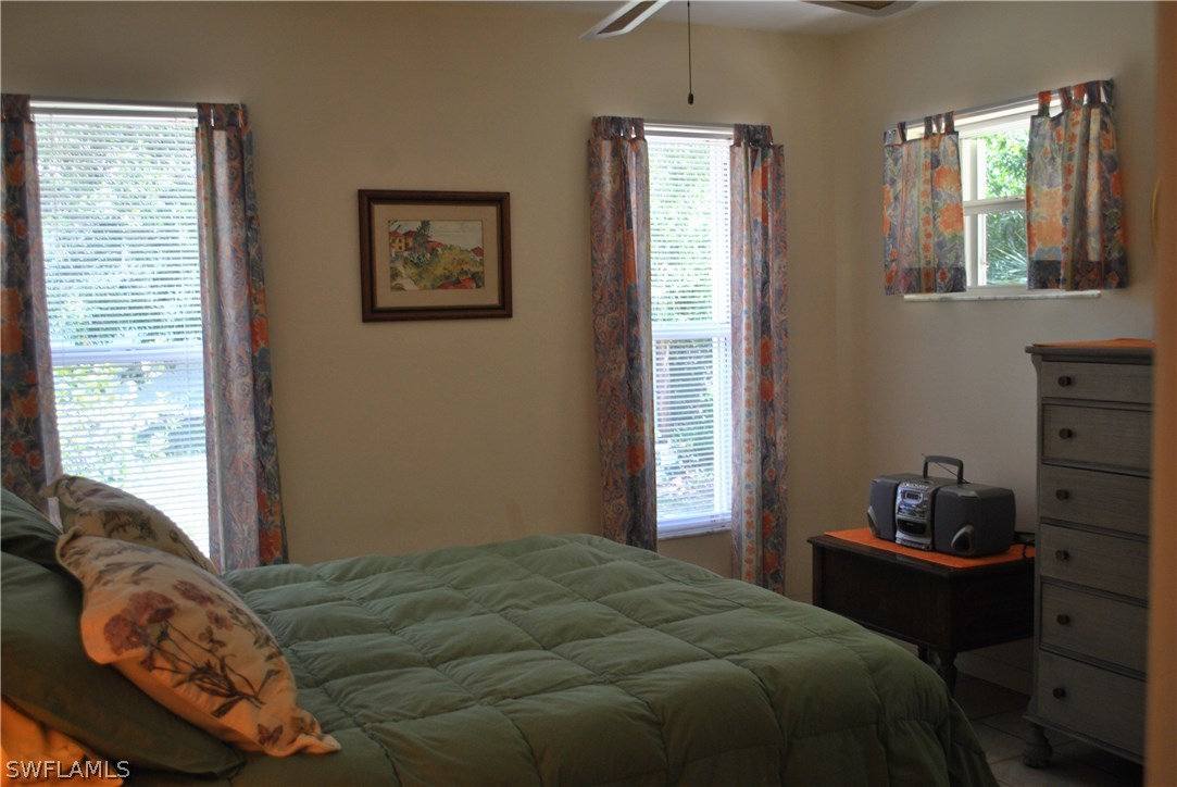 5824 Mackerel Road Bokeelia, FL 33922 - Photo 21 of 25 a bedroom with a bed and a window