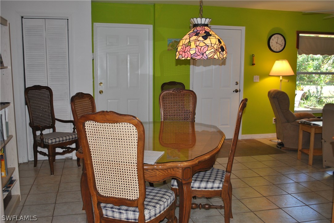 5824 Mackerel Road Bokeelia, FL 33922 - Photo 8 of 25 a dining room with furniture and a window
