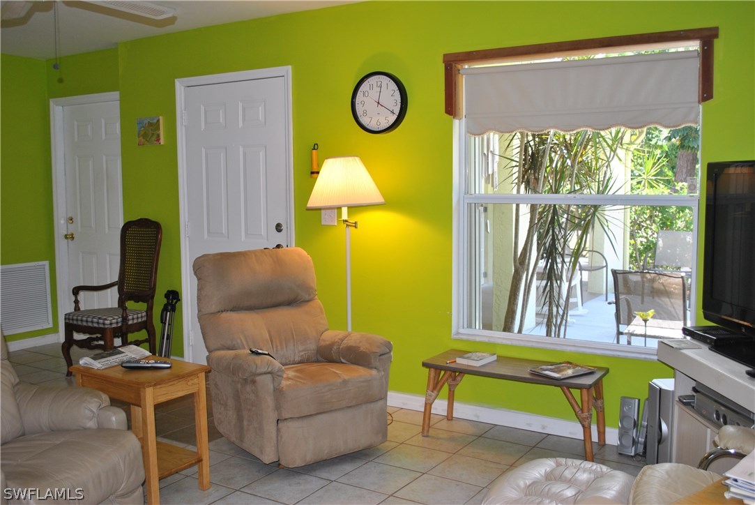5824 Mackerel Road Bokeelia, FL 33922 - Photo 9 of 25 a living room with furniture a flat screen tv and a window