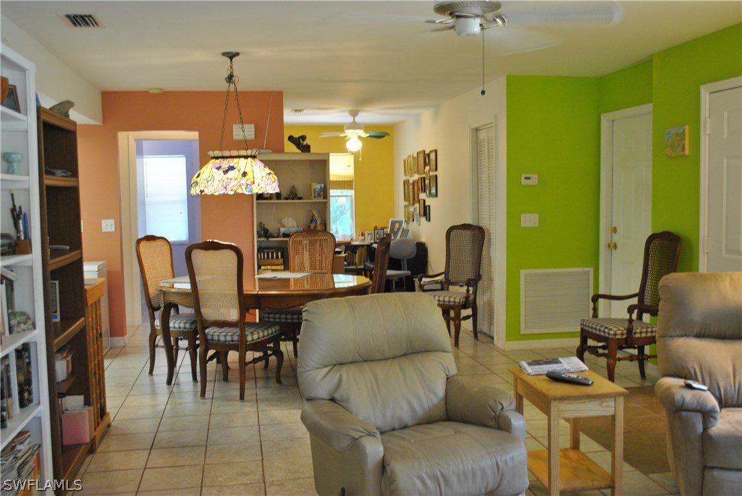 5824 Mackerel Road Bokeelia, FL 33922 - Photo 10 of 25 a living room with furniture and a chandelier