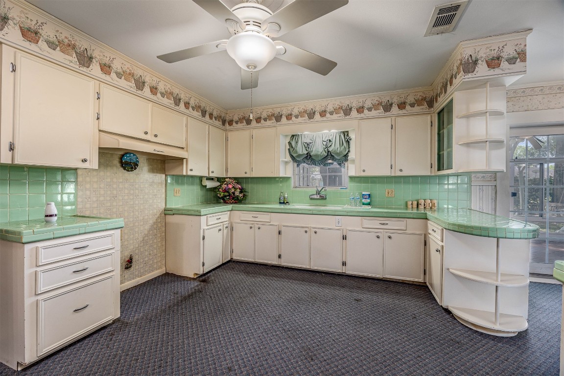 718 Nelson Street Crosby, TX 77532 - Photo 18 of 38 a kitchen with granite countertop white cabinets white appliances a sink and a stove